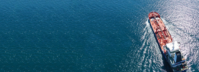 Aerial drone panoramic photo of industrial oil and fuel tanker cruising deep blue open ocean sea
