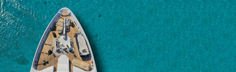 Aerial drone top down ultra wide photo of luxury yacht nose docked in tropical exotic bay - obrazy, fototapety, plakaty
