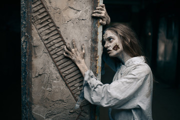 Female zombie in abandoned factory, devil