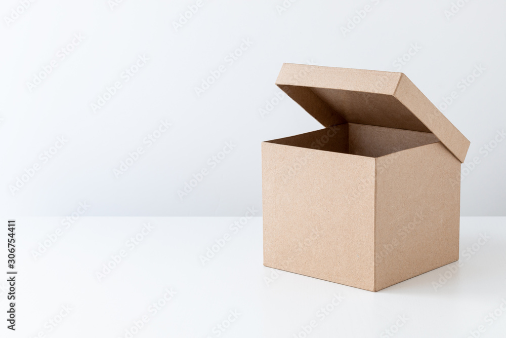 Wall mural half-open cardboard box, gift box, isolated on white.