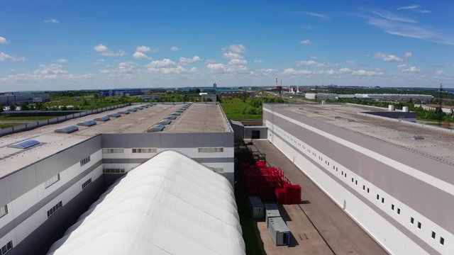 aerial motion over workshop building roofs under blue sky