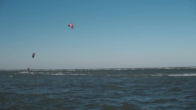 Extreme Kite Boarding Trick Over Camera In Sea. Young Man Kitesurfing in sea