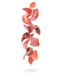 Beef jerky pieces fall down on a white background - obrazy, fototapety, plakaty