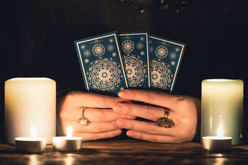 Fortune teller with tarot cards in hands close up. Future reading concept. - obrazy, fototapety, plakaty