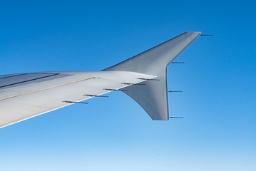 views of the plane's wing and the clear blue sky