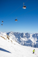 Gondola cable car and skier in Alps in Solden, Tirol, Austria