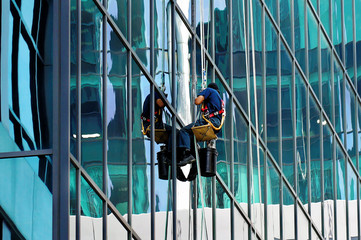 TORONTO, CANADA - 06 16 2016: Industrial climber cleaning the glassy wall of Canadian Broadcasting...