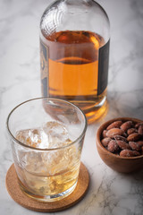 whiskey on the rocks with salted almond