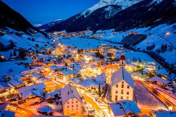 Winter night cityscape in the Austrian town of Neustift. Aerial view of the town center and the...
