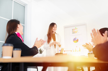 close up hand, audience clapping hands and feeling impressive, asian female officer present about organization business profits with executive board,  they discussion about development performance