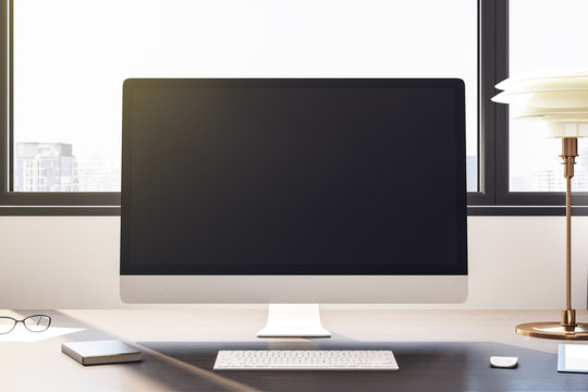 Desktop with empty black computer screen