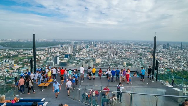 time lapse of unidentified people with panoramic view on 78th floor at King Power Mahanakhon building rooftop, Bangkok, Thailand