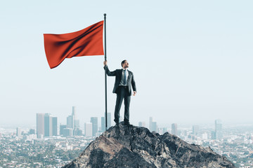 Happy businessman with red flag