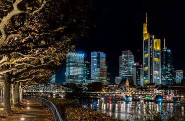 frankfurt skyline at night with colorful reflections in the main river, frankfurt am main, germany