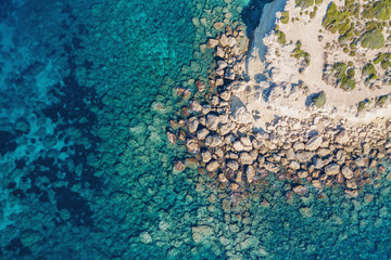 Cyprus coastline aerial top view from drone, Stone Rocks and azure mediterranean sea water in sunny day as beautiful nature resort background.