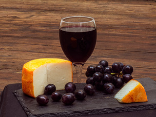 Pure Spanish goat cheese with grapes and a glass of red wine. (cheese from Extremadura. South of...