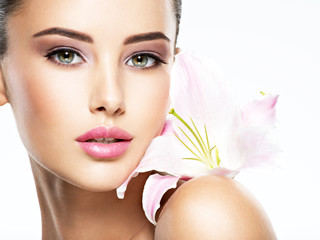 Beauty pure face of the young beautiful girl with flower