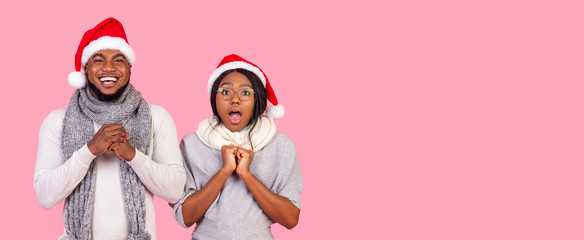 Emotional black girl and cheerful guy over pink background
