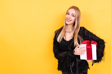 portrait of beautiful smiling girl with gift box