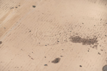 Oil stains on cardboard. Cheap oil leak absorbing.