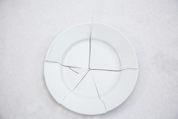 Picture of a broken disc causing danger from sharp objects falling onto a white background
