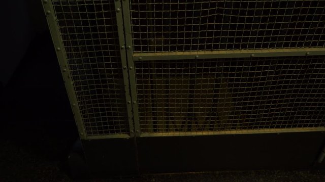 Antique old elevator coming up to floor in building. Transport in metal cage.