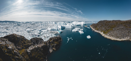 Iceberg and ice from glacier in arctic nature landscape in Ilulissat,Greenland. Aerial drone photo of icebergs in Ilulissat icefjord. Affected by climate change and global warming.