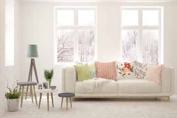 Stylish room in white color with sofa and winter landscape in window. Scandinavian interior design. 3D illustration