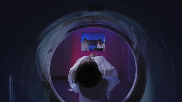 Tomograph. The patient on the CT scan. View through the tomograph from behind.