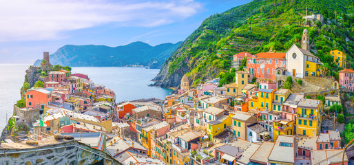 Vernazza village with typical colorful multicolored buildings houses, Castello Doria castle on rock, green hills and Genoa Gulf, Ligurian Sea, National park Cinque Terre, La Spezia, Liguria, Italy