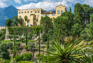 Fototapeta na wymiar Botanical gardens with view of Trauttmansdorff Castle - Meran, Trentino Alto Adige, northern Italy, august 2019.