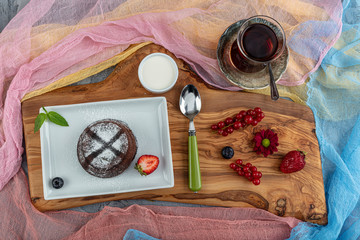 Close up Photograph of a chocolate souffle. Chocolate fondant lava cake with strawberries.