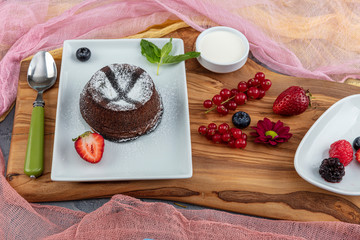 Close up Photograph of a chocolate souffle. Chocolate fondant lava cake with strawberries.