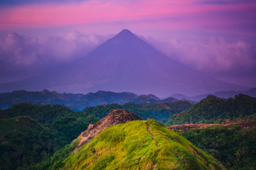 Sunset Mayon Volcano on Luzon Island Philippines. Wild Jungle Trees and Bushes, Mountain Peak and Cloudy Sky. Panoramic Photography on Amazing Exotic National Landscape View from Climb