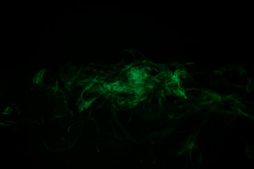 Obraz na płótnie Canvas Whispy Green Smoke on Black Background
