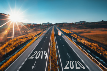 Driving on open road at beautiful sunny day to new year 2020. Aerial view