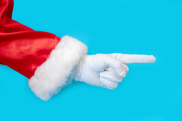 Santa Claus glove hand blue background one red suit copy space