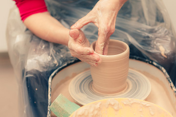 The process of creating a ceramic cup on a potter's wheel