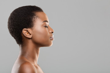 Profile portrait of black woman with perfect skin and closed eyes