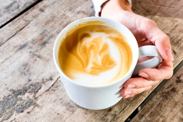 Cup of coffee in hand.