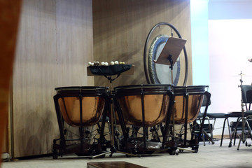 set of kettle-drums on the stage of concert hall