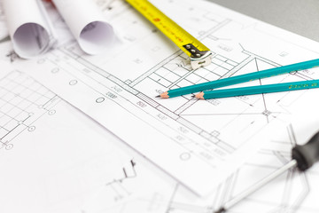 Architectural project, blueprints, blueprint rolls, ruler and pencil. Construction background.