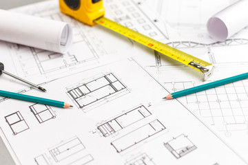 Architectural project, blueprints, blueprint rolls, ruler and pencil. Construction background.
