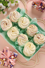 Homemade zephyr or marshmallows in a box on a pink background, Top view