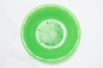 empty green plastic plates top view on white background