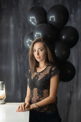 Charming young brunette posing near a table