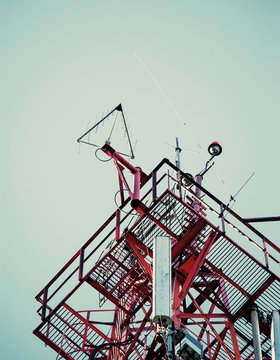 Telecommunication radio signal tower over the blue sky