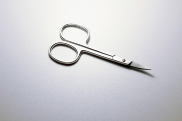 silver steel nail scissors. scissors on a neutral background