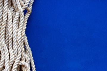 close up of a rope on blue background. space for text.