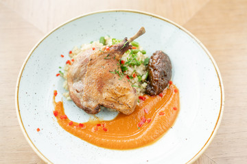 Plate Duck leg su-vide, with bulgur and onion marmalade. Barbecue restaurant menu, a series of photos of different meats